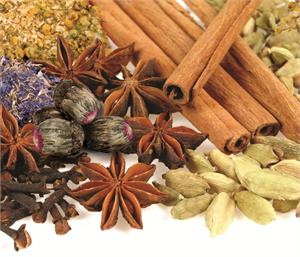 Close-up of various dried spices including cinnamon sticks and star anise.