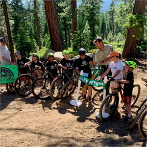 Kids and adults ready for a mountain bike ride in the forest.