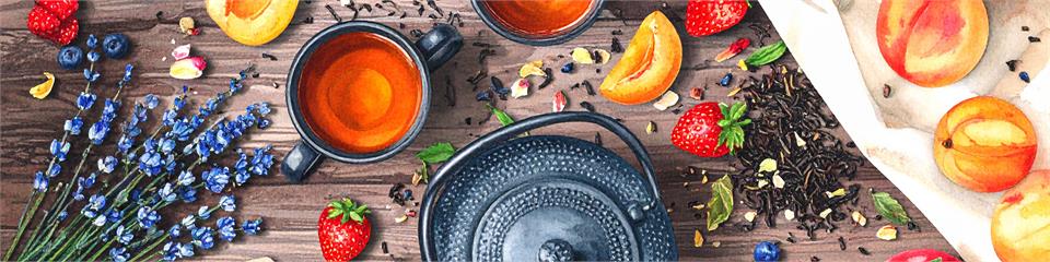 Tea set with cups, teapot, and tea leaves on a wooden surface with fruits and flowers.
