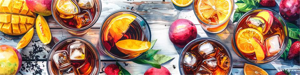 Assorted iced drinks with fruits and ice cubes on a wooden surface
