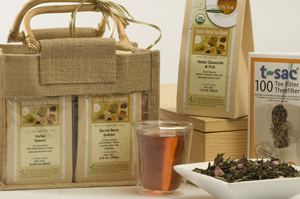 Packaged tea sets in burlap-like bags, with a glass of tea.